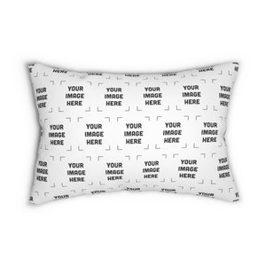 a white rectangular pillow with a black and white pattern