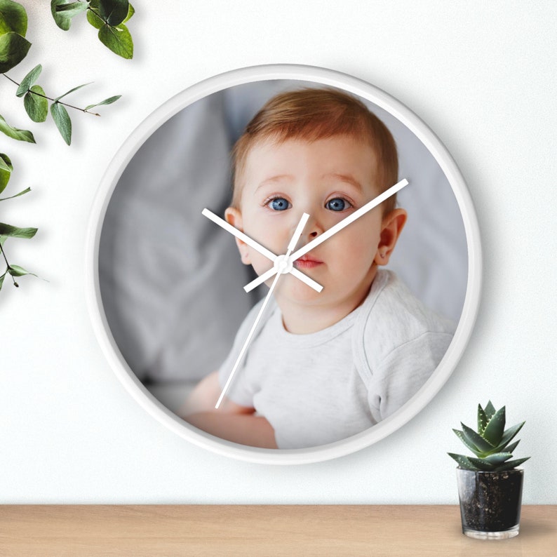 a clock with a picture of a baby on it