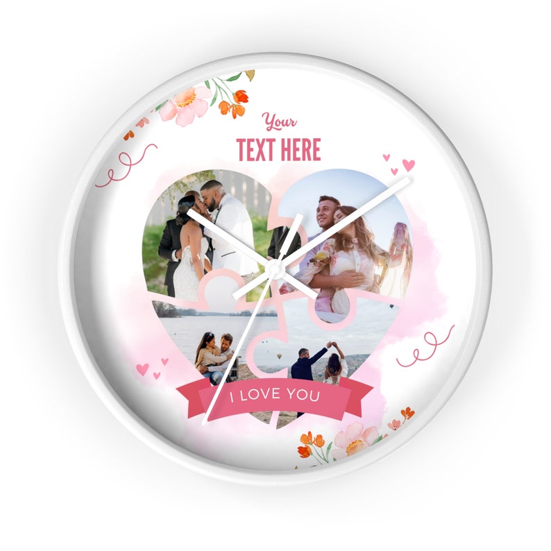May include: White round clock with a pink heart-shaped design featuring four photos of a couple. The heart is made up of puzzle pieces. The clock has a white background with pink floral accents and the text "Your Text Here" and "I Love You".