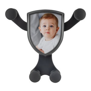 a baby's face is shown in a black frame