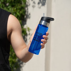 a person holding a blue water bottle in their hand