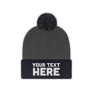 a beanie with a pom - pom on top of it