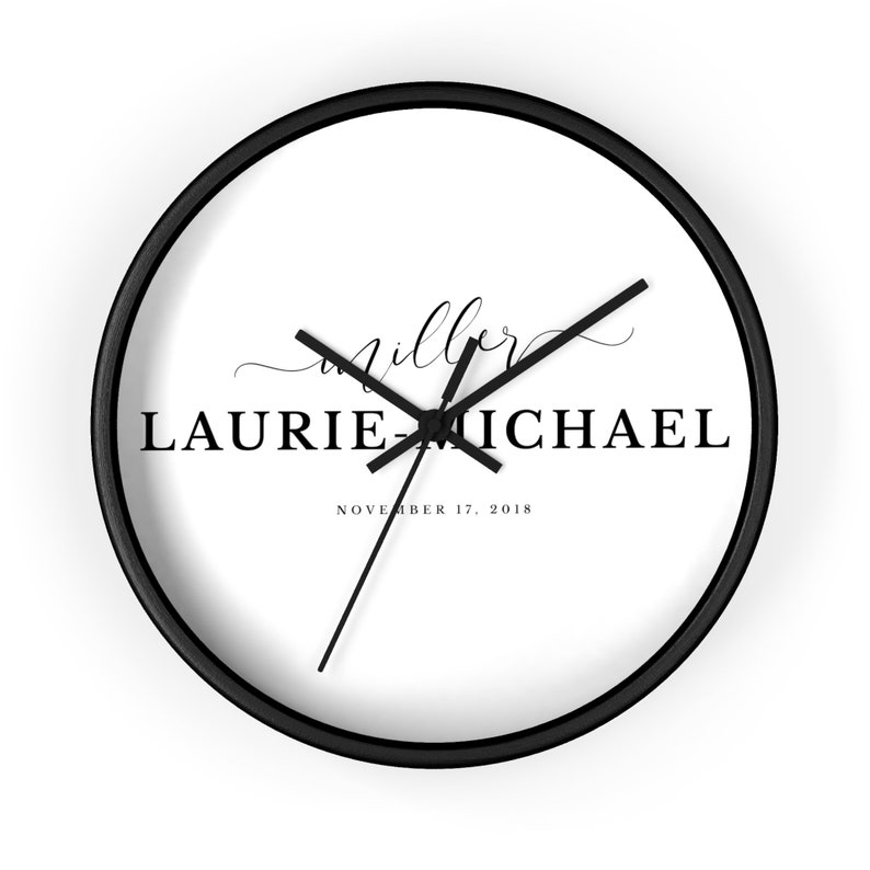 May include: A black and white personalized wall clock with the text "Miller Laurie & Michael November 17, 2018".