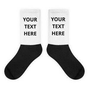 a pair of black and white socks with your text on them