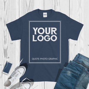 a t - shirt with the words your logo on it next to a pair of