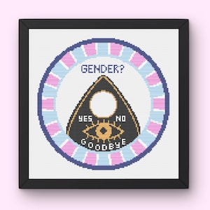 May include: A framed cross-stitch featuring a Ouija board design. The board is black with gold lettering and a circular pointer. The text "GENDER?" is at the top, with "YES", "NO", and "GOODBYE" on the board.