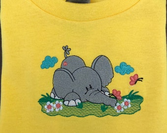 Boys or girls yellow tee shirt with a cute elephant enjoying the flowers