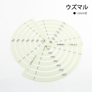 May include: A white plastic circle template with concentric circles marked in millimeters. The template is labeled "UZUMARU" and "1.6mm thick".