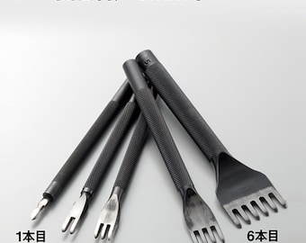 May include: Set of five black leather punch tools with different sized prongs. The tools are labeled 1-4, with the 6-prong tool labeled "6本目" and a note that there is no 6mm width.