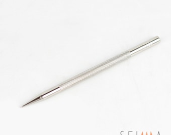 May include: A silver metal tool with a pointed tip and a textured handle. The tool is about 6 inches long.