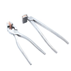 May include: Two silver metal pliers with copper-colored inserts. The pliers have a curved handle and a flat jaw.