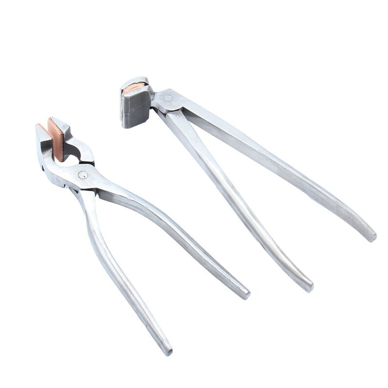 May include: Two silver metal pliers with copper-colored inserts. The pliers have a curved handle and a flat jaw.