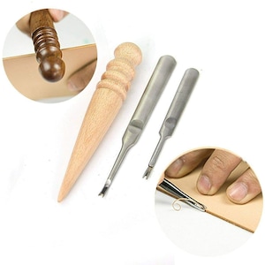 May include: A set of leather working tools including a wooden stitching awl, a stitching groover, and a stitching pricker. The tools are used for hand stitching leather.