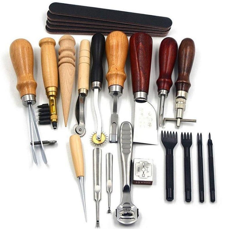 May include: A set of 20 leather craft tools with wooden handles. The tools include awls, stitching chisels, a stitching groover, a stitching pony, a stitching wheel, a leather skiver, and a leather punch. The tools are arranged on a white background.