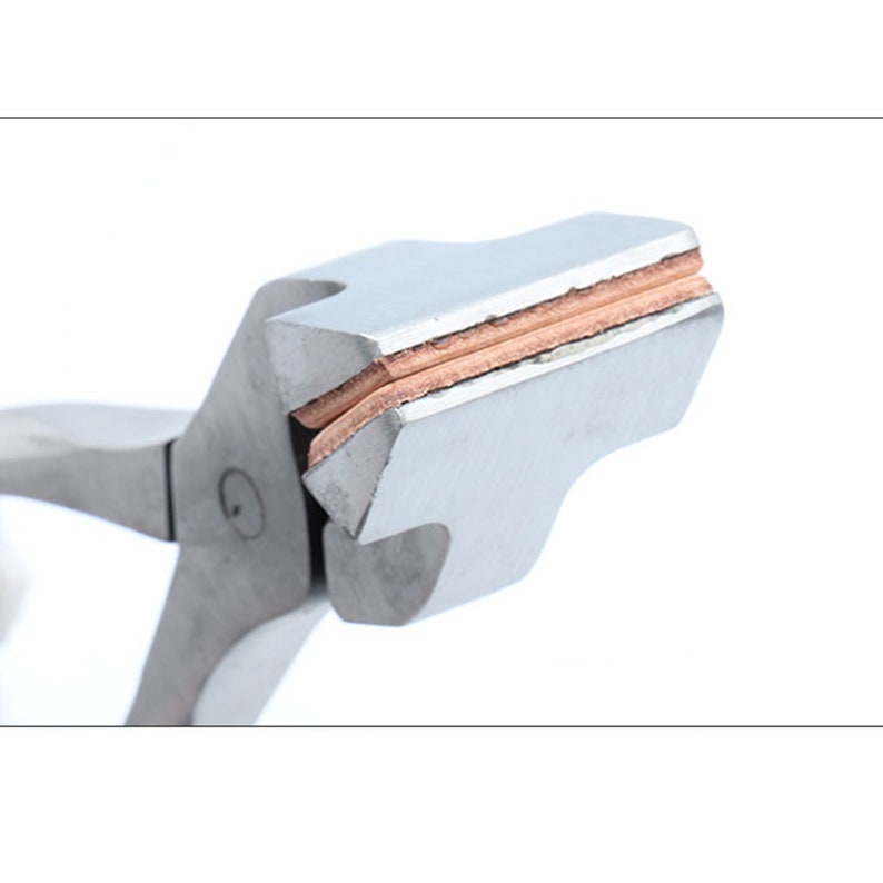 May include: Close-up of a silver metal tool with copper-colored pads on the jaws. The tool is designed for crimping jewelry findings.