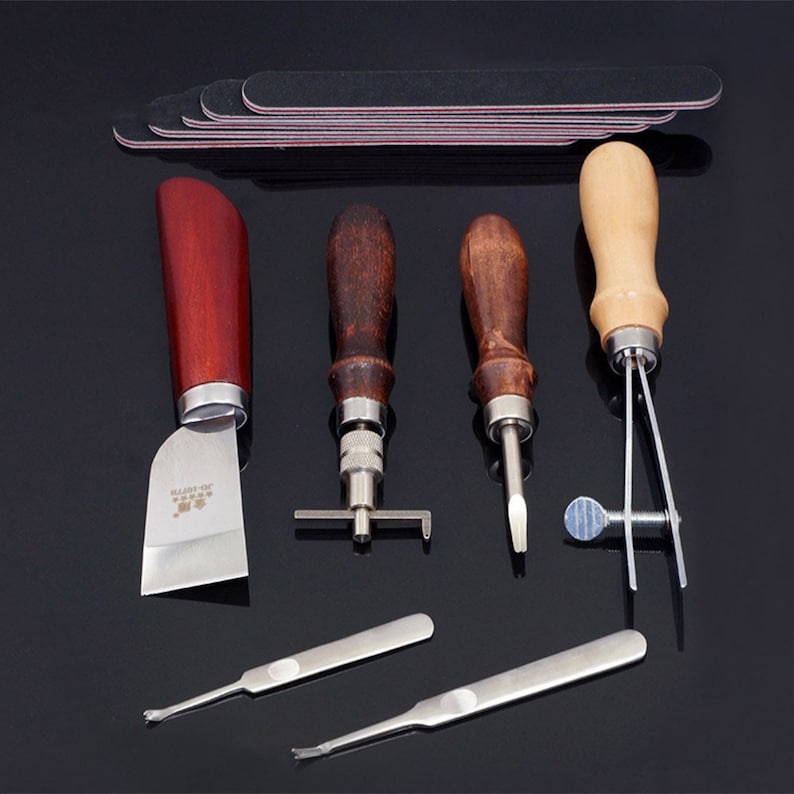 May include: Leather craft tools set with a variety of tools including a stitching awl, a stitching pony, a leather skiver, and a set of sanding files.