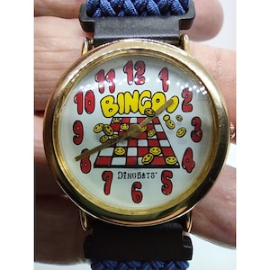 Reloj humorístico para mujer con tarjeta de bingo Dingbats