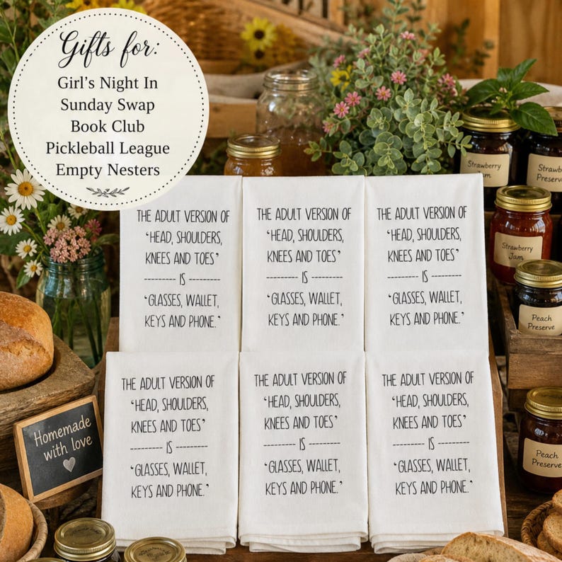 photograph showcasing six of these premium towels in a shingle display on a rustic wooden farmhouse table. The scene should is enriched with artisan jellies and freshly baked homemade breads, capturing the warm, abundant atmosphere of a Sunday swap harvest exchange aesthetically pleasing text overlay reads: Gifts for: Girl's Night In, Sunday Swap, Book Club, Pickleball League, Empty Nesters The Adult Version Of Head, Shoulders, Knees Toes is Glasses Wallet Keys Phone Kitchen Tea Towel