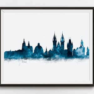 May include: A watercolor painting of the Prague skyline in shades of blue. The cityscape features several prominent buildings, including the iconic Prague Castle and the Charles Bridge.