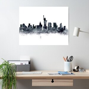 May include: A black and white watercolor illustration of the New York City skyline, featuring the Statue of Liberty and other iconic buildings.