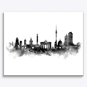 May include: Black and white watercolor illustration of the Berlin skyline, featuring iconic landmarks like the Brandenburg Gate, the Berlin TV Tower, and the Reichstag building.