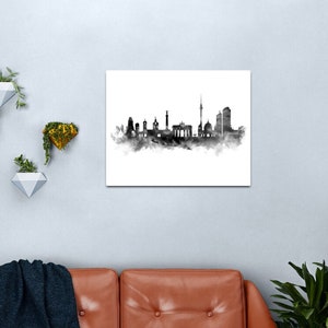 May include: Black and white watercolor illustration of the Berlin skyline. The skyline includes the Brandenburg Gate, the Berlin Cathedral, and the Fernsehturm.