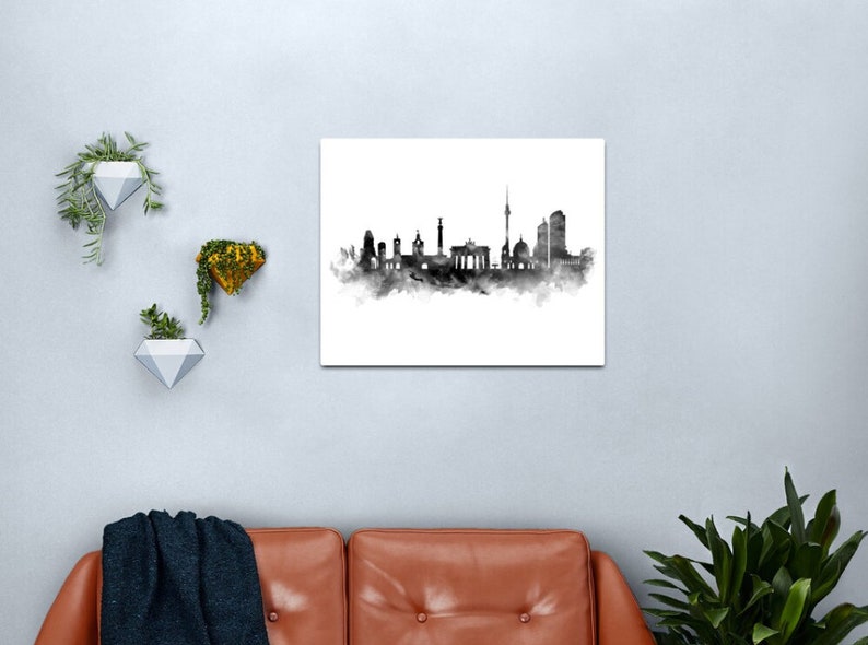 May include: Black and white watercolor illustration of the Berlin skyline. The skyline includes the Brandenburg Gate, the Berlin Cathedral, and the Fernsehturm.