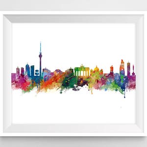 May include: A watercolor painting of the Berlin skyline, featuring iconic landmarks like the Brandenburg Gate and the TV Tower. The cityscape is rendered in vibrant colors, with splashes of blue, green, yellow, and red.