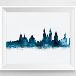 May include: A watercolor painting of the Prague skyline in shades of blue. The cityscape features several prominent buildings, including the iconic Prague Castle and the Charles Bridge.