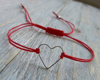 Red string bracelet with silver heart charm and macrame knot for adjustable fit