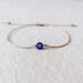 Gold string evil eye bracelet, Blue evil eye hematite bracelet, Amulet, Protection bracelet, Minimalist bracelet, Tiny adjustable bracelet 