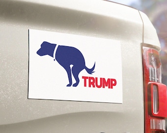 May include: A white car magnet featuring a blue silhouette of a dog defecating with the word "TRUMP" in red letters.