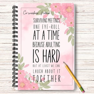 May include: A pink and green floral design notebook with the text "Co-worker Name" at the top and the text "Surviving meetings one eye-roll at a time because adulting is hard but at least we can laugh about it together" in black text.