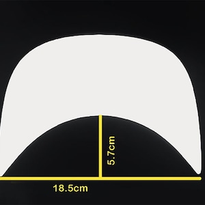 May include: A white, arched object with dimensions labeled in centimeters. The object is 18.5cm wide, 13cm tall, and 5.7cm at its deepest point. The background is black.
