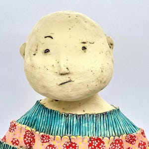 Unique ceramic sculpture, whimsical ornament, art doll, decorative ceramic doll, red sculpture, quirky ceramic figure, cute art doll.