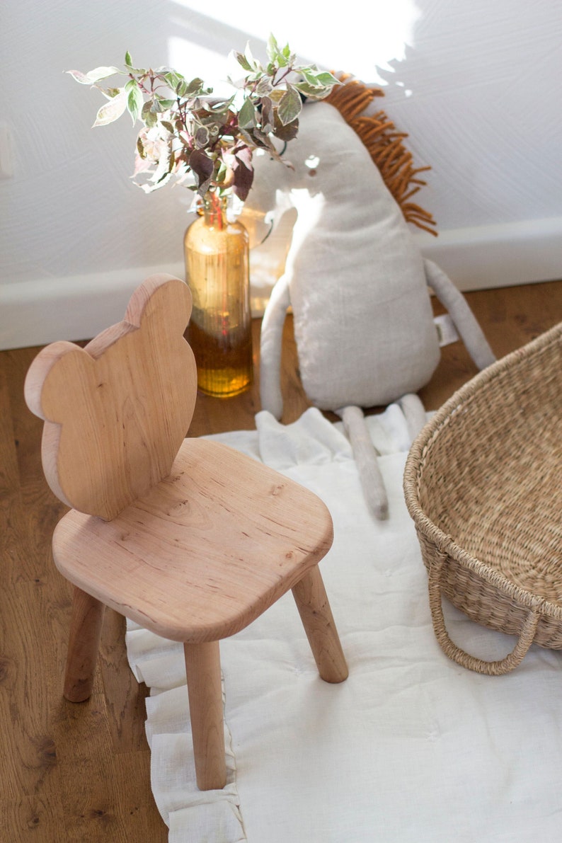 Wooden chair with bear shaped backrest. Natural color, rounded corners, soft to touch. Sturdy and stable chair.