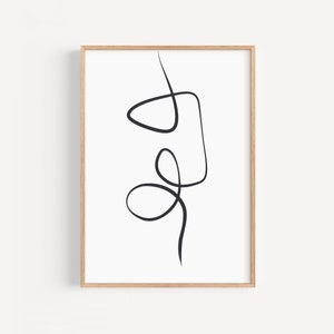 May include: A black and white abstract line art print with a simple design of overlapping circles and squares. The print is framed in a light wood frame.