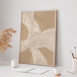 May include: A framed abstract print with a beige background and white lines forming a wavy pattern.