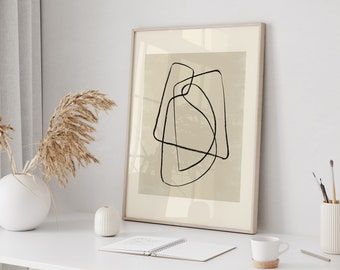 May include: A framed abstract art print with a beige background and black line drawings of overlapping geometric shapes. The frame is light wood and the print is hanging on a white wall.