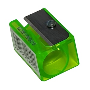 May include: A green plastic pencil sharpener with a silver blade. The sharpener has a clear plastic ring around the center and the brand name "KOH-I-NOOR" printed on the side.
