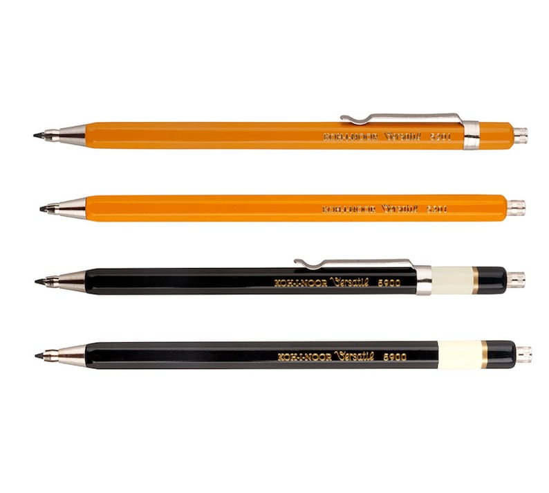 May include: Four mechanical pencils, two orange and two black, with the brand name "KOH-I-NOOR Versatil" printed on each. The pencils have a metal clip and a metal tip.