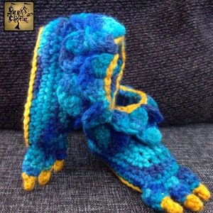 May include: Crocheted slippers in blue and yellow with a claw-like toe design.