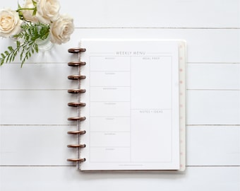 May include: A white weekly menu planner with a spiral binding. The planner has sections for each day of the week, meal prep, and notes and ideas.