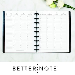 May include: A black and white weekly planner with a black cover and silver rings. The planner is open to the week of January 31st to February 6th. The planner has a section for each day of the week with lines for writing. The planner has the text "January" and "THIS WEEK" at the top.