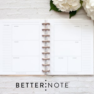 May include: A white weekly planner with a gold coil binding. The planner has sections for each day of the week, Monday through Sunday, and a notes section. The planner is on a white brick background.