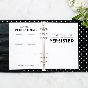 May include: A black and white polka dot planner with a white page open. The page has the text "monthly reflections" and a table with the headings "What went well?", "How will I keep it up?", "What didn't go well?", "How will I change?", "Goals for next month", "How will I achieve them?", and "This month was a 1-5 star rating". The right page has the text "nevertheless she persisted".
