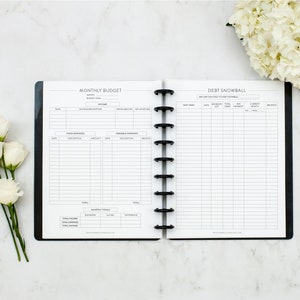 May include: A black and white printable budget planner with two sections: "Monthly Budget" and "Debt Snowball". The planner includes sections for income, fixed expenses, variable expenses, and debt snowball tracking.