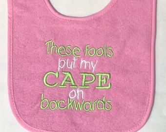 These fools put my cape on backwards embroidered bib