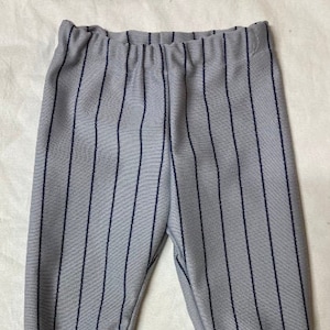 May include: Gray striped pants with a dark gray waistband.
