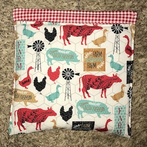May include: A white fabric tote bag with a red and white gingham trim. The bag features a farm-themed print with cows, pigs, chickens, windmills, and the text "Farm Fresh Everyday" and "Farm Sweet Farm".